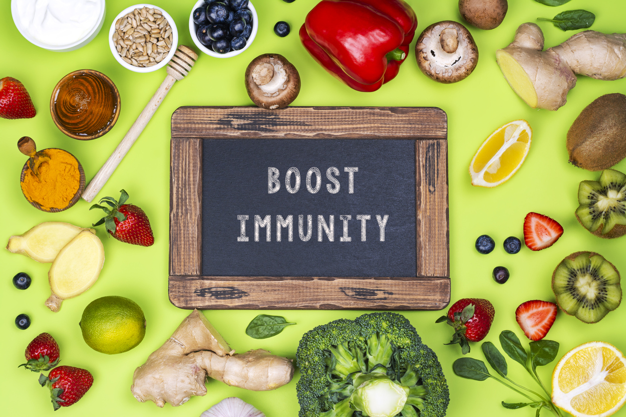Fruits and Vegetables around a chalkboard that says "Boost Immunity"